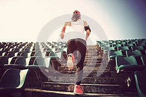 Athlete running on stairs. woman fitness jogging workout wellness concept.