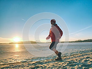 Athlete running woman runner jogging on winter beach