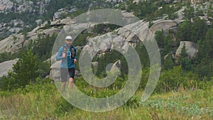 Athlete runs a cross-country marathon in the mountains. Trail running active lifestyle