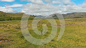 Athlete runs cross-country in the mountains in summer