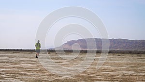 The athlete runs through the desert. Cross Country Running