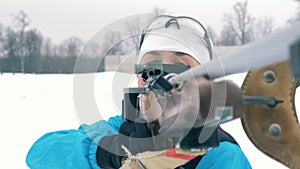 Athlete shoots on a range, while competing in a biathlon race. 4K