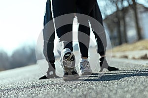 Athlete simulating starting blocks on the street