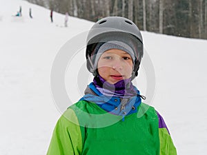Athlete a skier in a helmet cheerful portrait on the ski slope