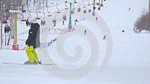 Athlete skiing on snowy sloping hill at ski resort