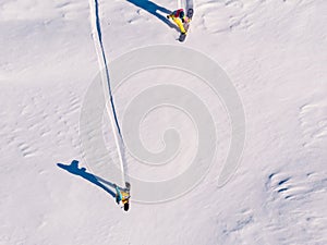 Athlete snowboarder rides off-piste clean snow snowboard, untouched in forest on slope. Aerial top view