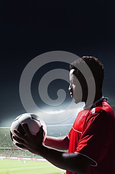 Athlete with soccer ball in stadium