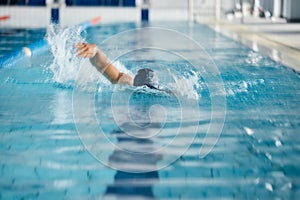 Athlete, speed or freestyle stroke in swimming pool cap for sports wellness, training or exercise for body healthcare