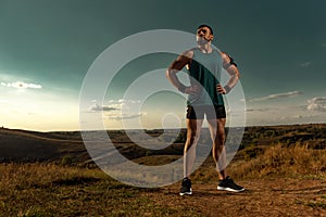 Athlete sprinter run. Strong athletic man running on sunset background wearing in the sportswear. Fitness and sport