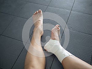 Athlete staring at her injured ankle photo