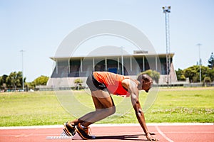 Athlete on a starting block about to run