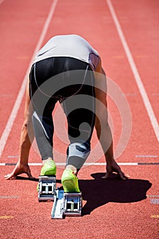 Athlete on a starting block about to run