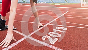 Athlete starting line on running track with 2019 year
