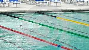 Athlete swimming crawl stroke in pool, training before competition, water sports