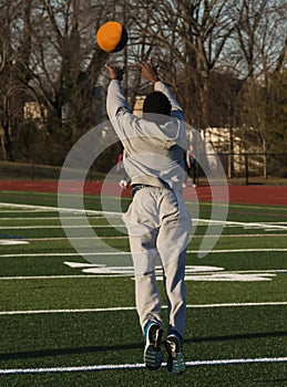 Athlete throwing a medicine ball foward and jumping photo