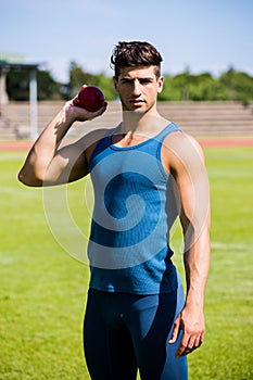 Athlete about to throw shot put ball