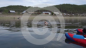 Athlete trains to swim in the river butterfly stroke.