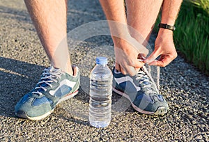 The athlete tying shoelaces close up