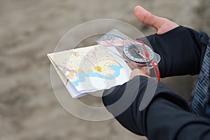 Athlete uses navigation equipment for orienteering,compass and topographic map