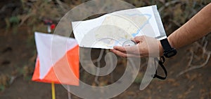 Athlete uses navigation equipment for orienteering,compass and topographic map