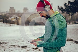 Athlete using mobile phone and listening music outdoor