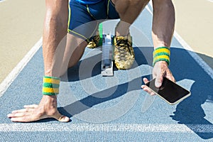 Athlete Using Mobile Phone on the Track