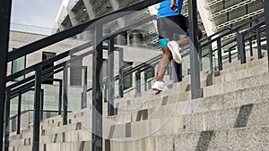 Athlete warming up before competition, running upstairs near stadium active life