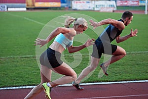 Athlete woman group running on athletics race track