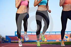 Athlete woman group running on athletics race track