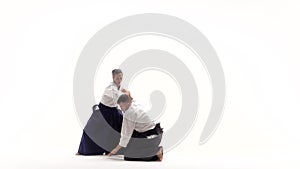Athlete and woman practicing aikido, isolated on white. Slow motion.