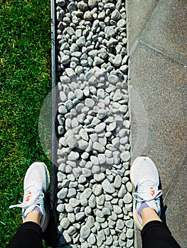 Athlete woman in sneakers on walking path