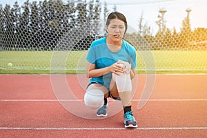 Athlete woman suffering from pain in leg with knee injury after sport exercise running jogging