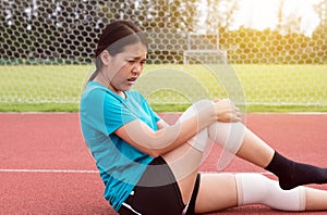 Athlete woman suffering from pain in legs with knee injury after sport exercise running jogging and workout