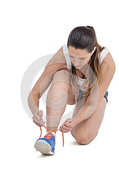 Athlete woman tying her running shoes