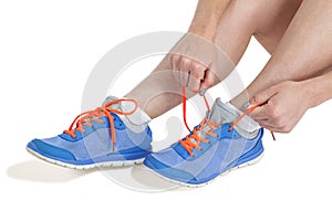 Athlete woman tying her running shoes