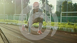 Athlete woman waiting in the starting block on running track 4k