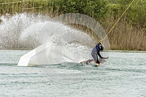 Athlete Woman is Wakeboarding at the Cable Park photo