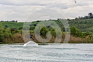 Athlete Woman is Wakeboarding at the Cable Park photo