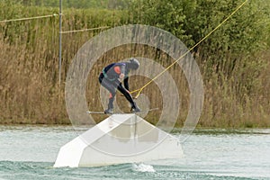 Athlete Woman is Wakeboarding at the Cable Park photo