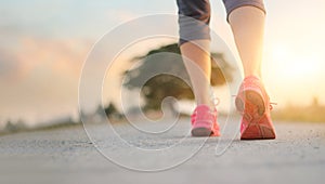 Athlete woman walking exercise on rural road in sunset background, healthy and lifestyle concept photo