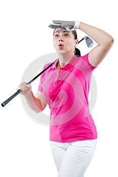 Athlete woman watching the ball flight path of golf on a white b