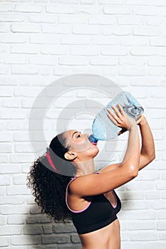 Athlete Young Woman Drinking Water From Bottle For Sport Fitness photo