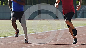 Athletes actively training at outdoor sports ground, preparing for competition