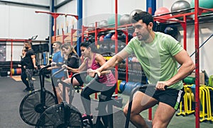 Athletes doing air bike indoor