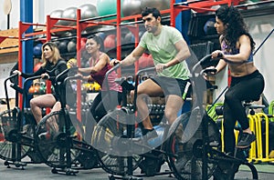 Athletes doing air bike indoor