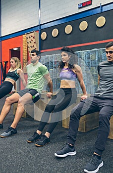 Athletes exercising doing box squats
