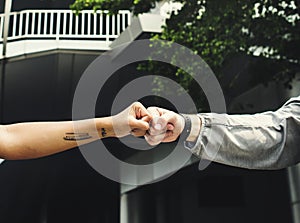 Athletes fist bump together outdoors