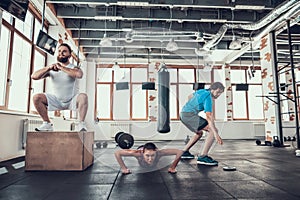 Athletes In Gym. Squats Push Ups And Relay Race