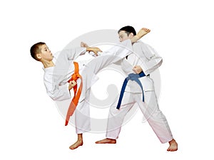 Athletes karate are training paired exercises on a white background