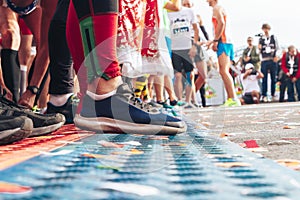 Athletes legs close-up in front of the start line